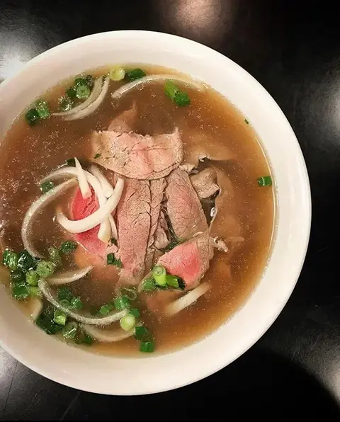 Bowl of pho with rare beef and herbs